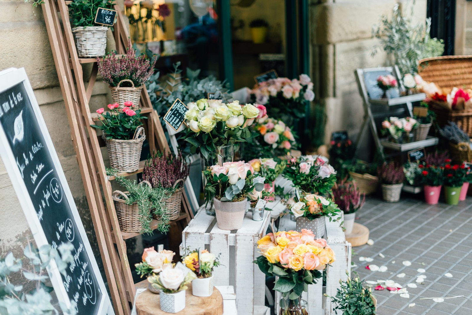 Florist hands arranging seasonal flowers at the Wildfen studio bench
