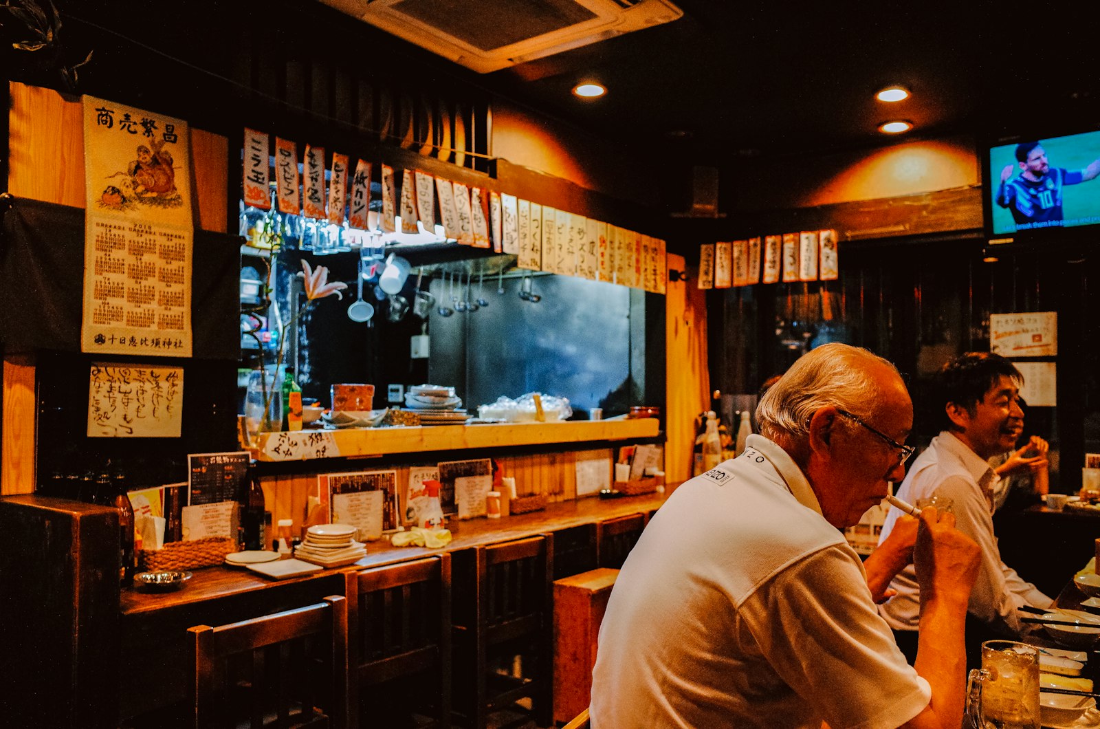 Warm interior of the Kaen Ramen counter at night
