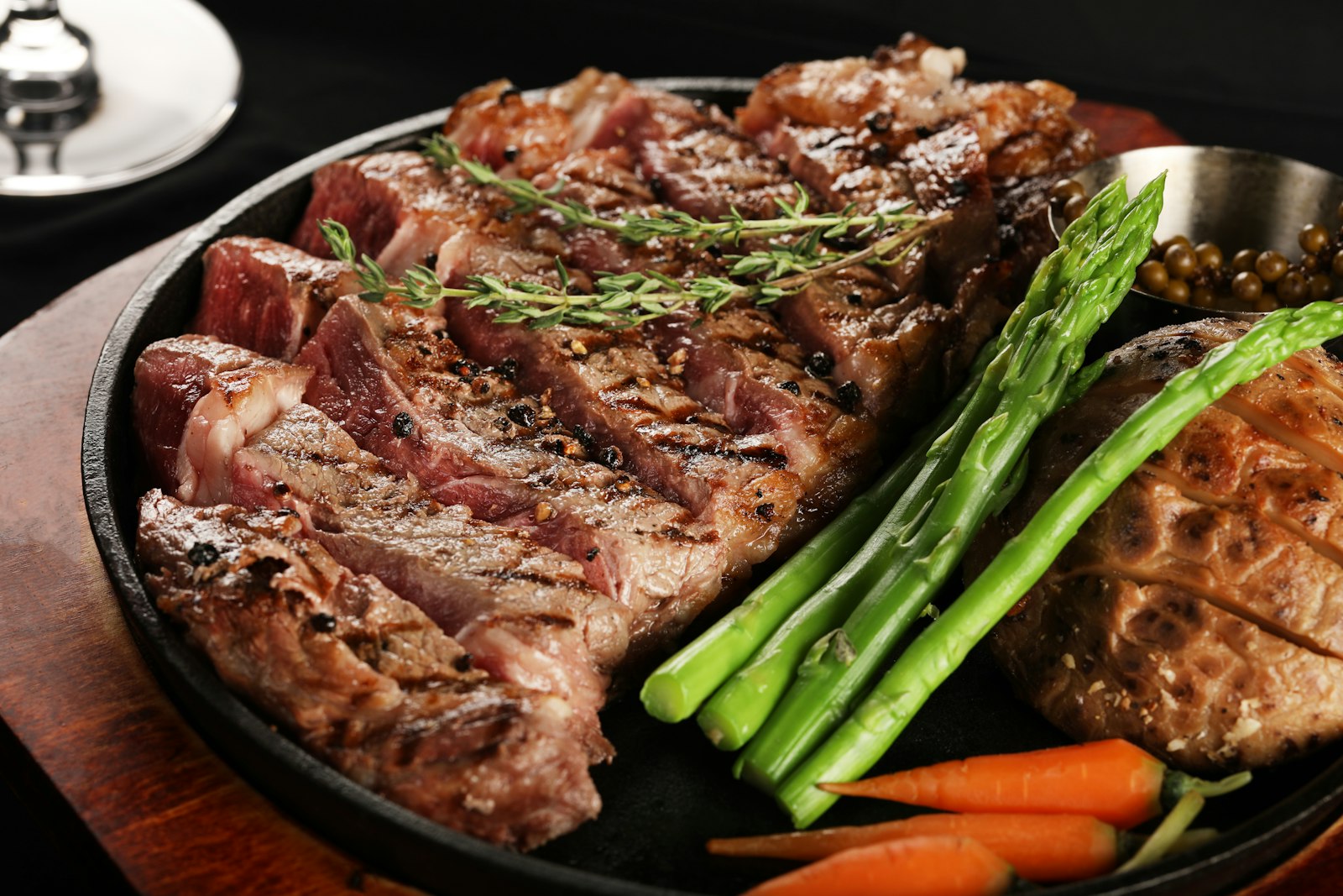 A plated dry-aged steak under candlelight