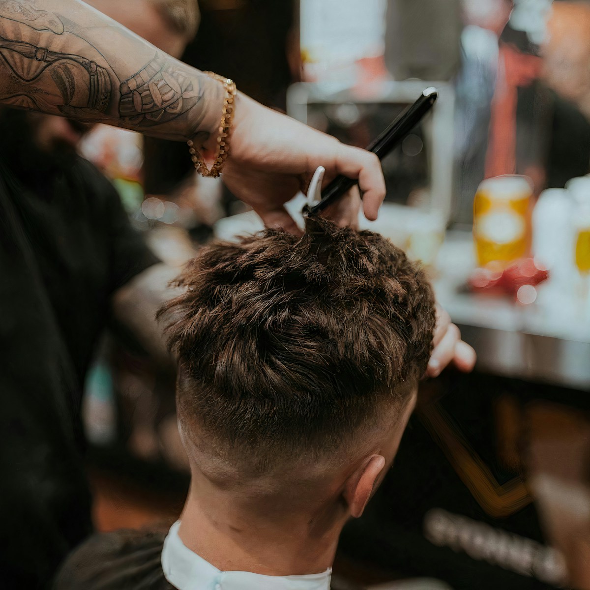 Barber trimming a beard at Golden Hair Salon
