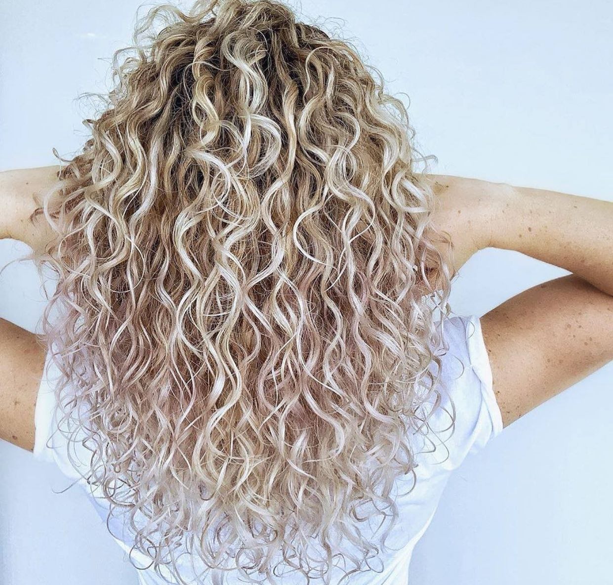Long curly blonde highlights by Huron Unisex Hair Salon, London Ontario